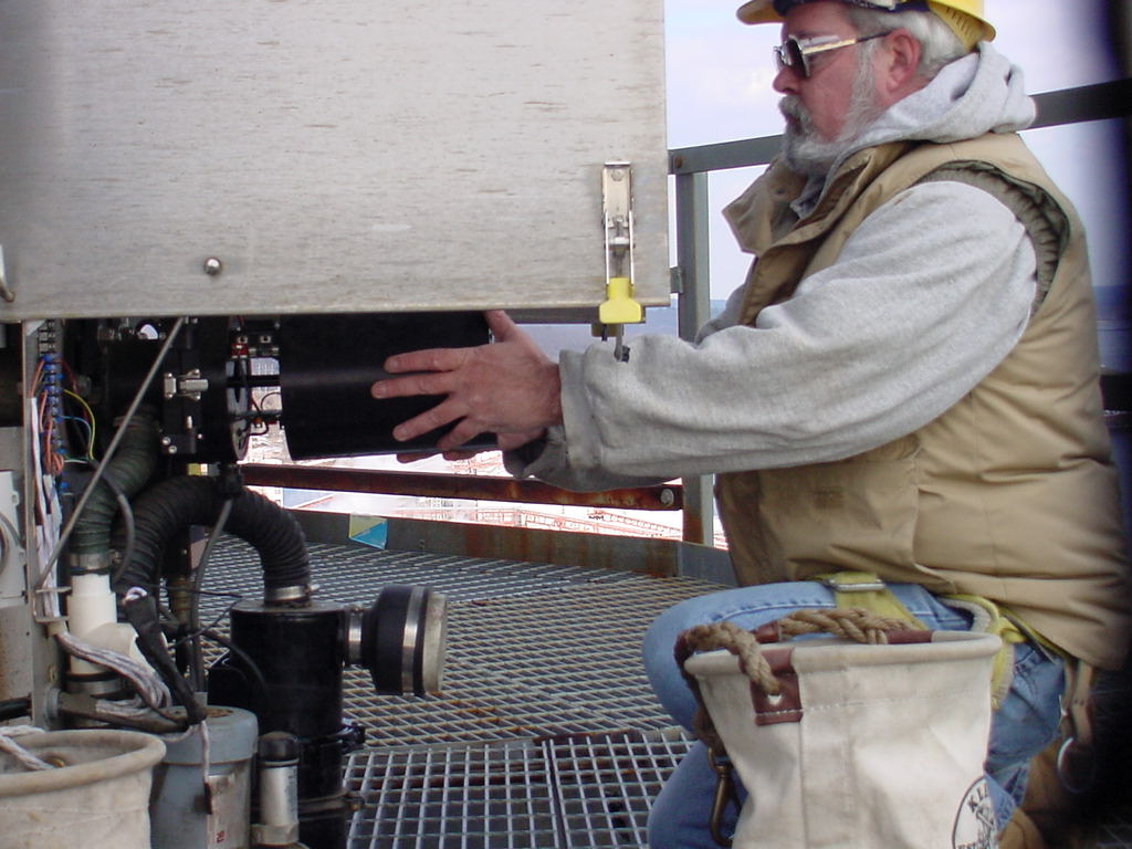 EMS field service technician servicing an industrial opacity monitor